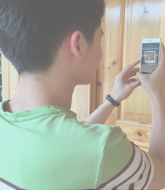 A guest scanning the QR code on a room door with his phone to check in