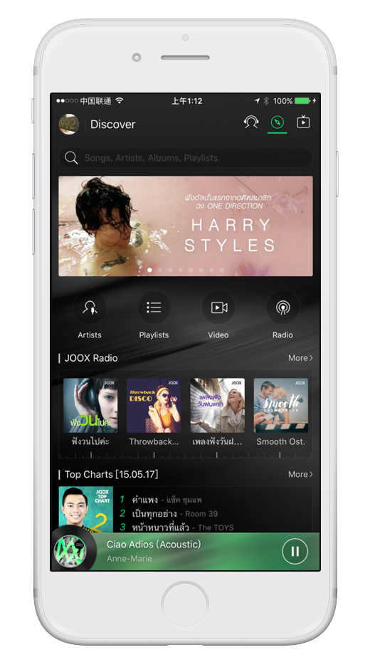 JOOX Discover screen on an iPhone with a featured artist banner, JOOX Radio and Top Charts
