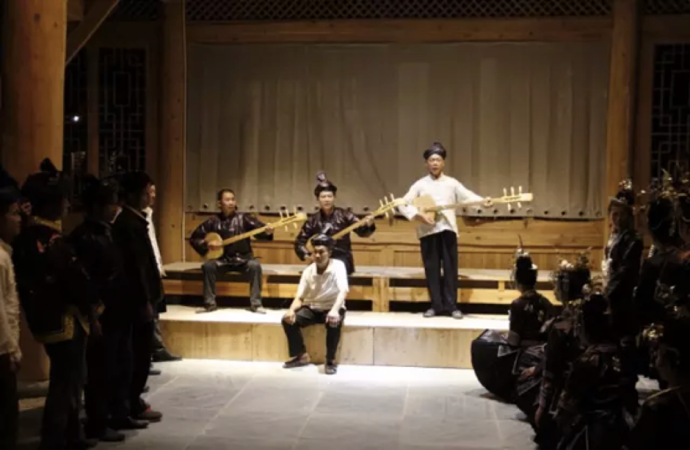 Villagers perform their folk songs with their traditional instrument for tourism
