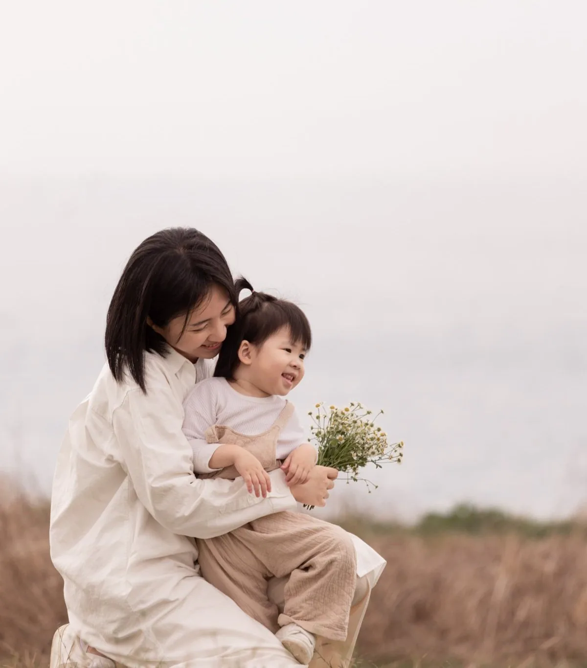 Rita Chou with her daughter, who is holding wildflowers
